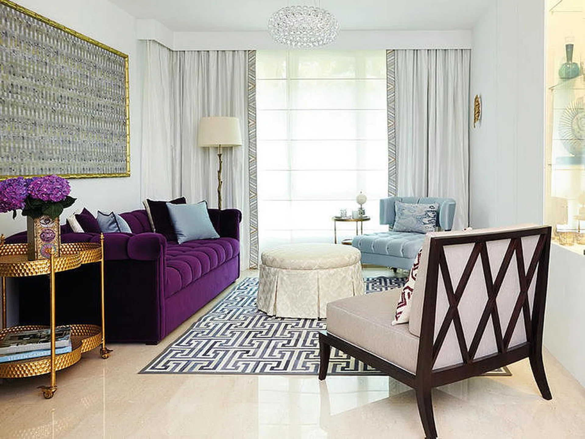 Vibrant shades of rich purple, and gilded finishes contrast dramatically with the otherwise muted tones of the living area of this 3-bedroom condominium in Bukit Timah.