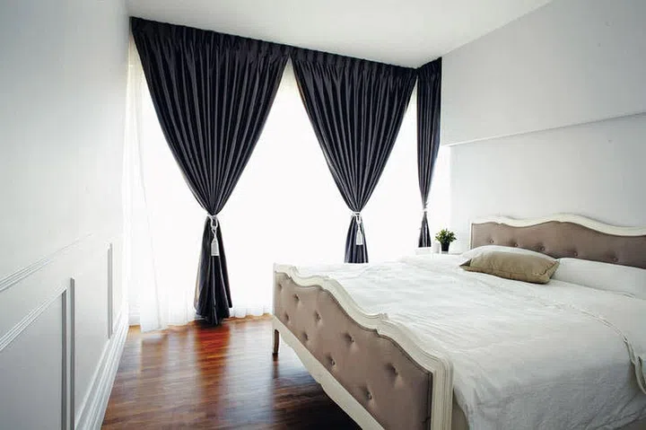 Wainscoting wall panels in an all-white bedroom.