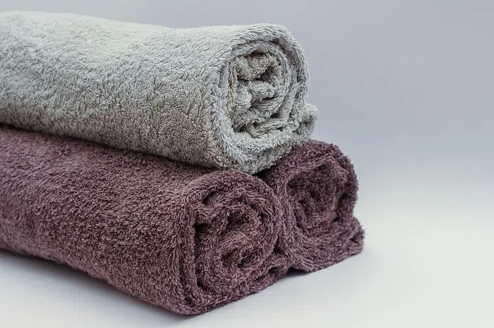 Close up of three rolled up bath towels.
