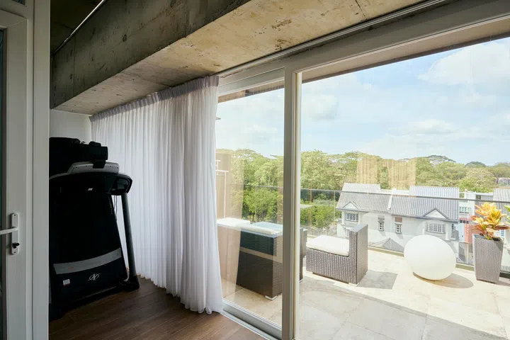 Sliding doors open to a terrace, extending the fourth-floor living space outward and framing viewas of the surrounding neighbourhood.