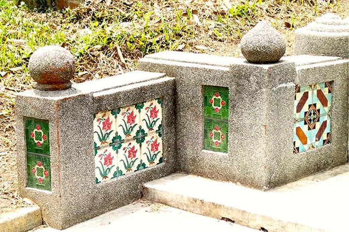 Peranakan tiles line graves at the Bukit Brown Cemetery.