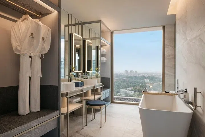An open bathroom with two sinks and a bathtub.