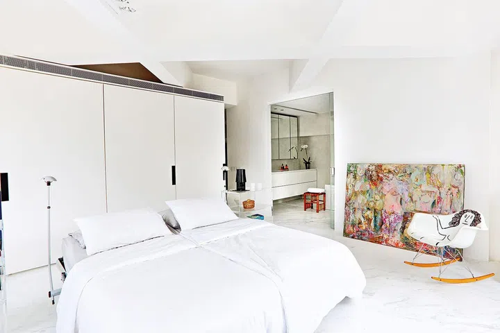 A dash of quirkiness and a touch of colour through the furnishings and artwork make this bright, white oasis even more inviting.