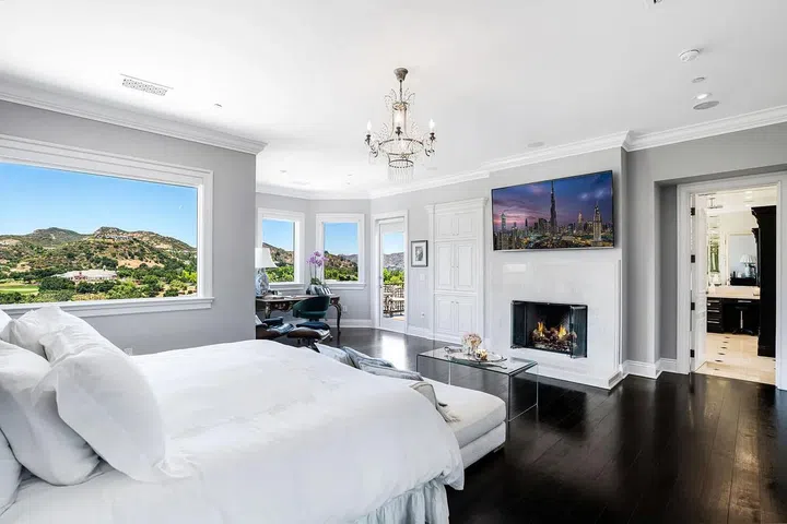 The spacious primary suite includes a fireplace.