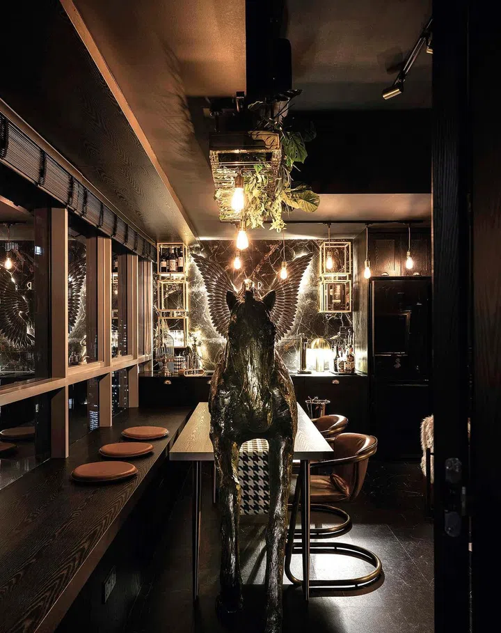The ceiling showpiece above the dining area is both a wine rack and a hanging planter. 