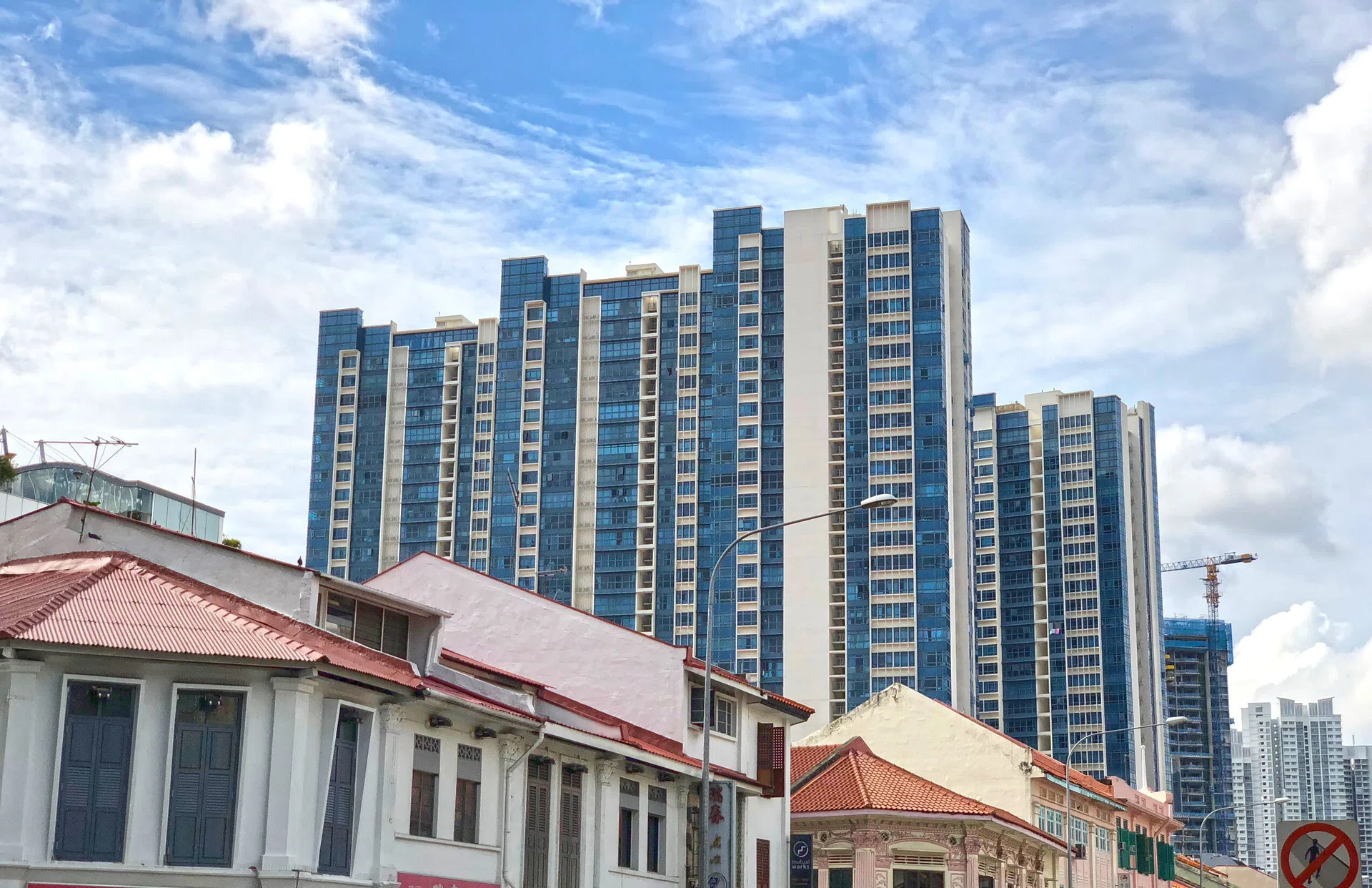 Singapore modern housing residential blocks behind row of old shop house - fusion/ contrast concept.