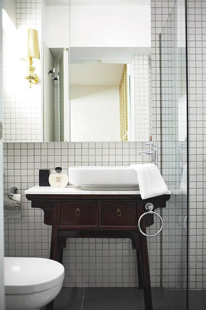 This antique dressing drawer was fitted with a stone top and modern-style bathroom sink! Interior design by Blupin I.D