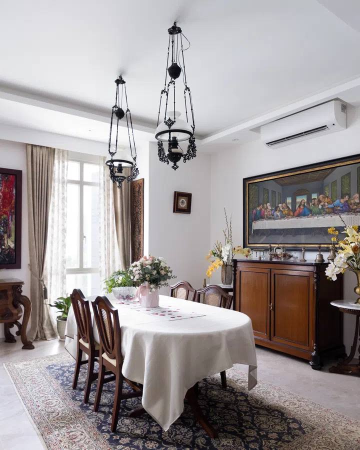 The dining room exudes a humble extravagance with heavy teak and marble furniture in this 3-bedroom condo in Orchard Scotts.