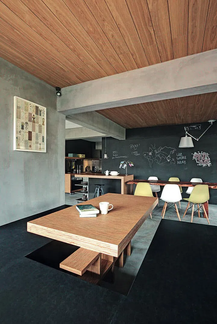 Quirky elements meet industrial chic: This convivial space is enlivened by the chalk scribbles on the blackboard paint wall.
