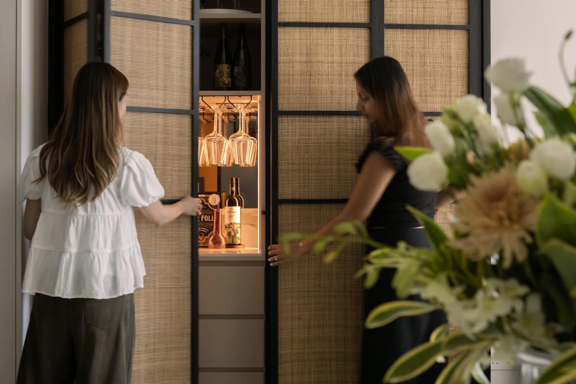 The arched rattan cabinet door design creates a striking focal point for the home.