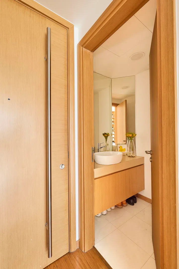 The powder room is kept simple and functional, finished in warm timber tones that echo the rest of the home.