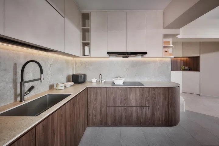 The kitchen countertop is a Vulcan sintered stone. "We picked it to match the neutral tone of the house and complement the peninsula. The countertop and backsplash are one seamless piece," says homeowner Ben.