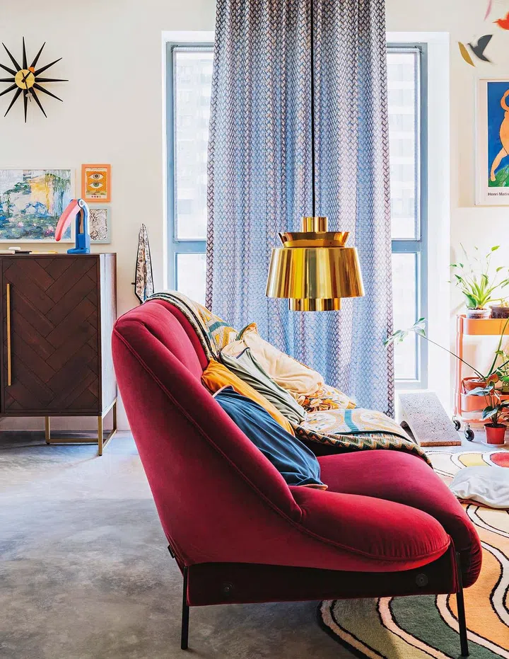 Aside from mixing colours, the homeowners love to play with shapes, creating a dynamic space. A rich, velvet red Païpaï sofa from Ligne Roset anchors the living area.