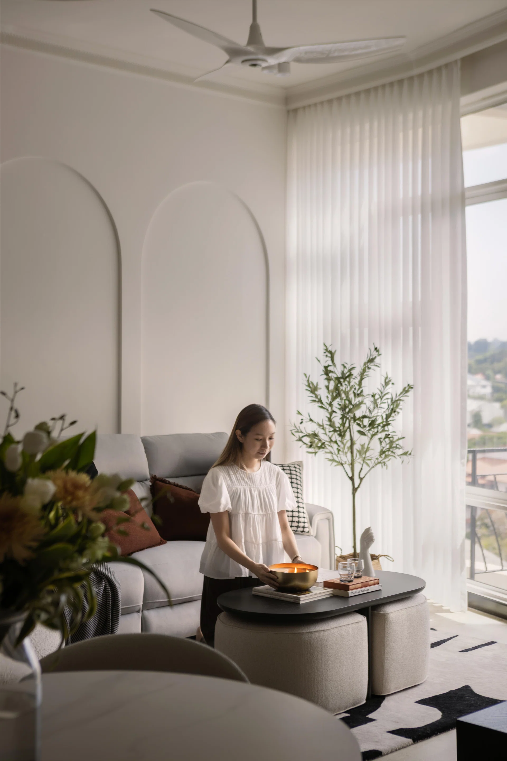Homeowner of the 3-bedroom condominium in Tanglin (1,399 sq ft) poses for a photo in the living room Interiors designed by Studio HP.