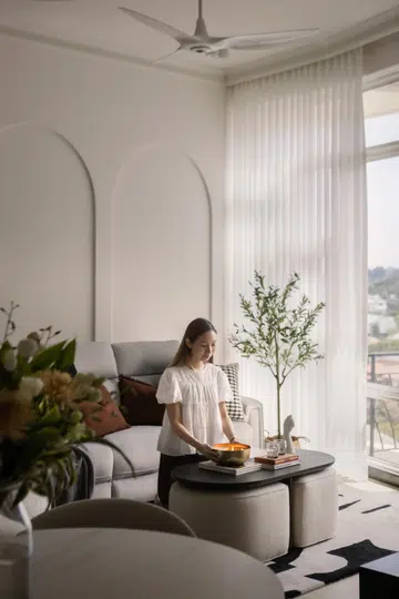 Homeowner of the 3-bedroom condominium in Tanglin (1,399 sq ft) poses for a photo in the living room Interiors designed by Studio HP.