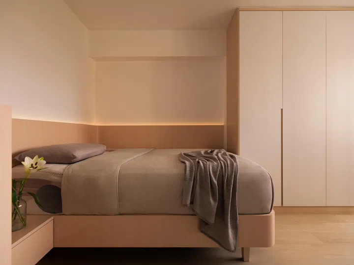 An existing cabinet from a previous renovation was retained, with the customised bed and built-in bedside drawer designed to align neatly around it.