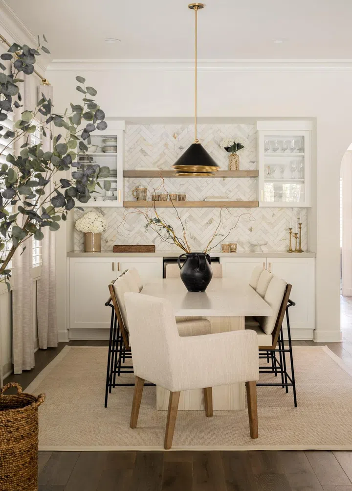 White, cream, and brown dining room with geometric interior design. Interior Design by Lundstrom Interiors. Photo by Elizabeth Nielsen