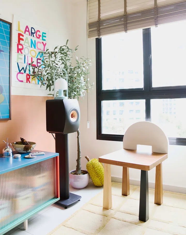 A close-up of the multicoloured HAY TV console paired with a playful stool.