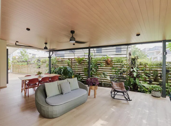 The covered terrace extends the living room into the landscape, creating an inviting outdoor space for family meals, quiet afternoons and birdwatching.