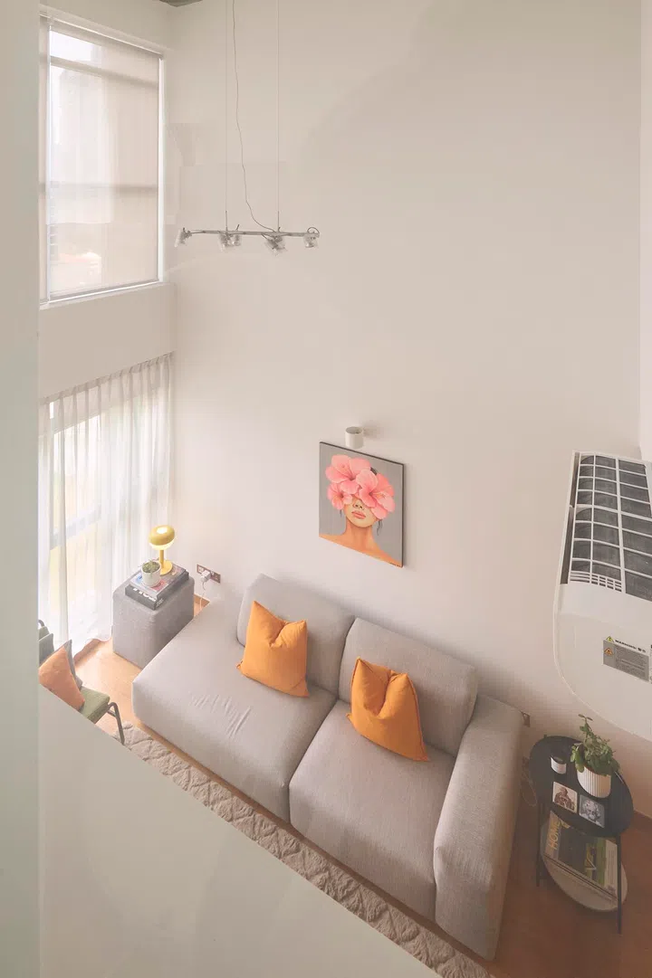 Viewed from the loft, the living area reveals a compact footprint beneath the double-height ceiling.