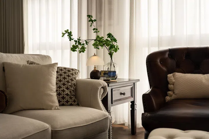 Plush furniture pieces in a combination of neutral and solid tones.