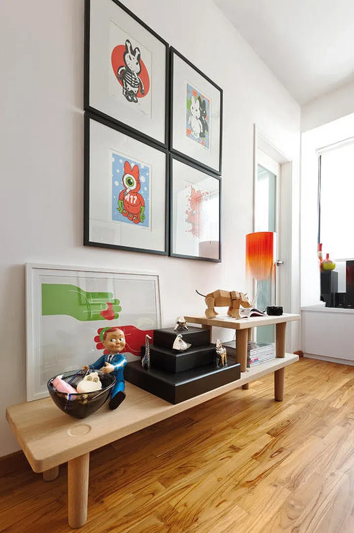 Displaying toys and cartoon characters in the study gives the kid's bedroom an unexpected playful touch in this 2-bedroom apartment with a $130,000 renovation. Interior design by Distinct Identity.