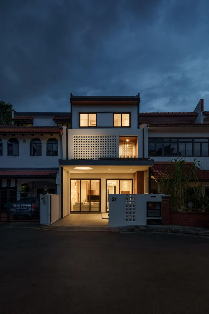 After dark, concealed lighting around the circular skylight throws light upward onto the breeze block façade, revealing the depth and texture of the home’s defining architectural feature.