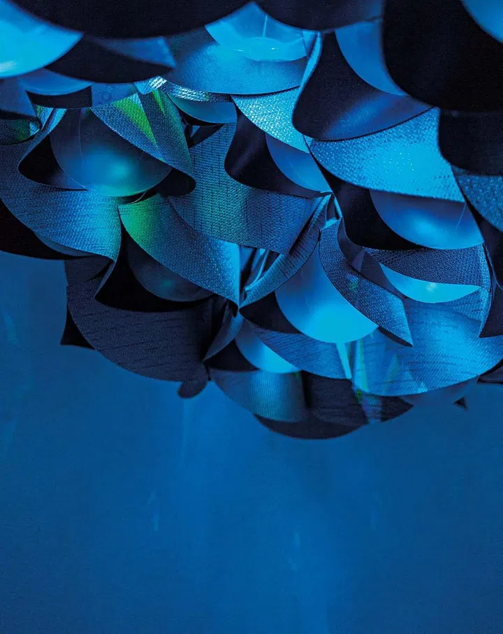 The texture of the material is highlighted with the use of light diffusing through the folds of the final artwork.
