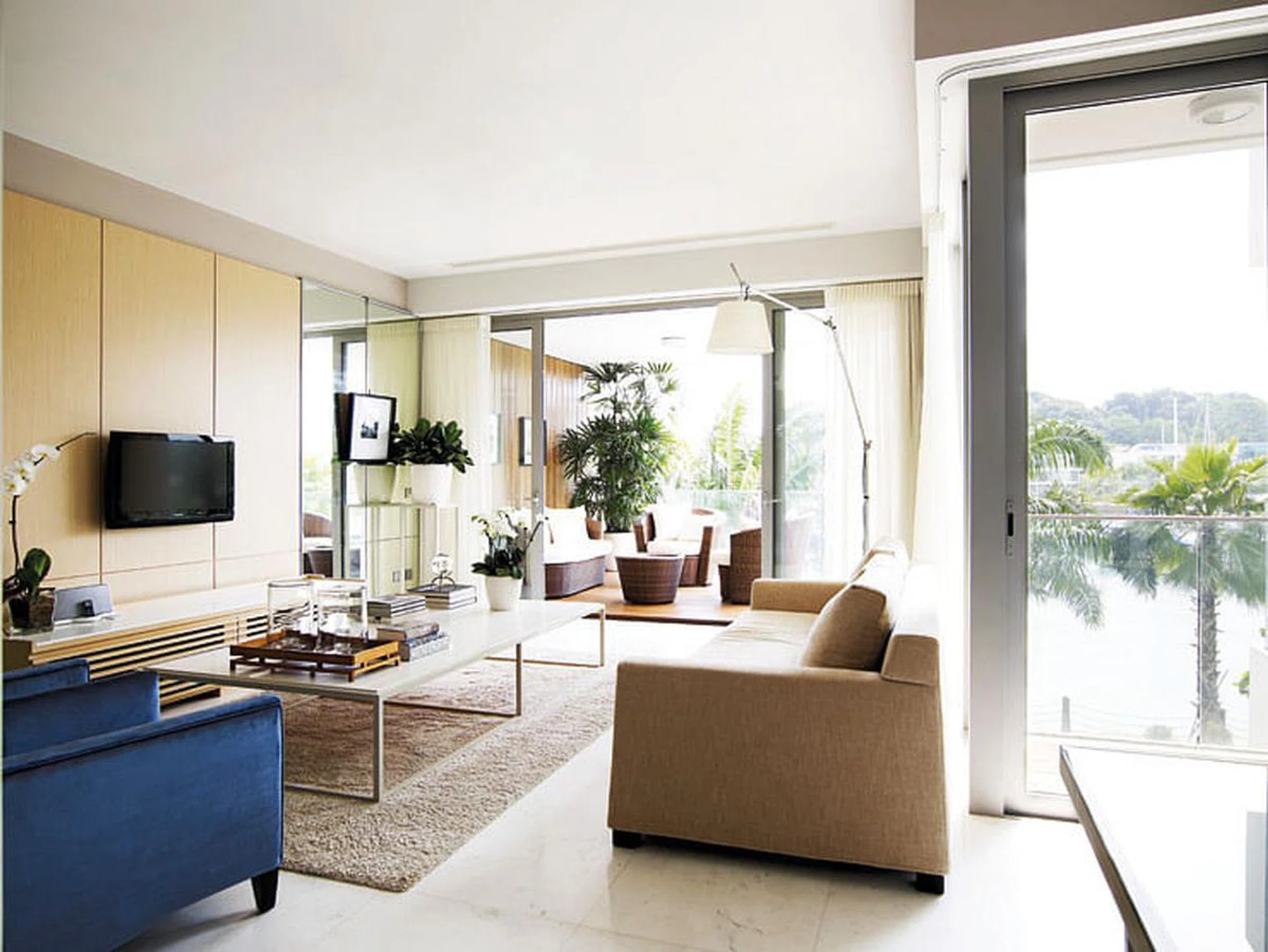 Living room in a 4-bedroom apartment in Oceanfront @ Sentosa Cove condominium with luxurious interior design.