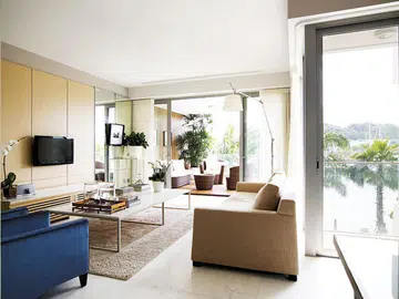 Living room in a 4-bedroom apartment in Oceanfront @ Sentosa Cove condominium with luxurious interior design.