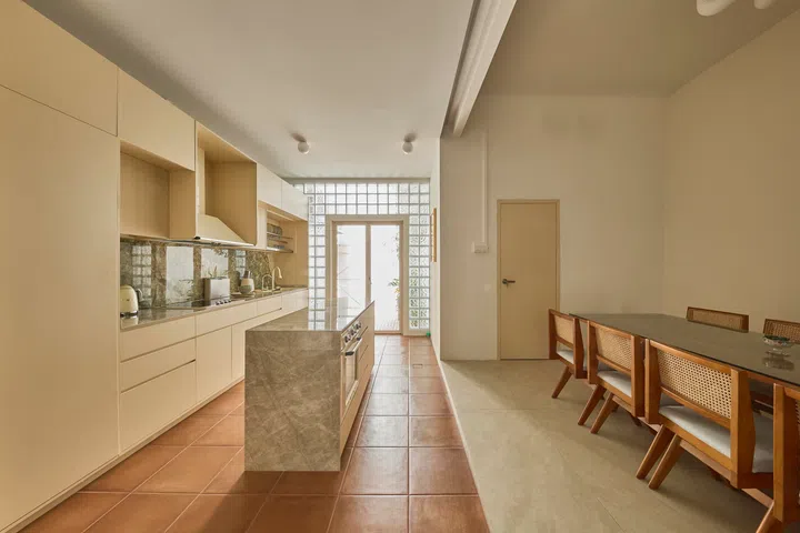 The dining area sits at the heart of the open-plan layout, created by integrating a former bedroom into a larger shared space.