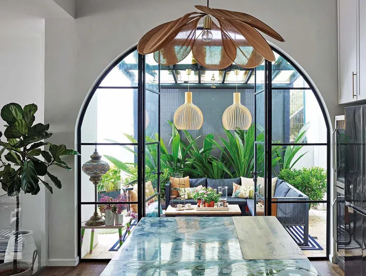 The dry kitchen extends to an outdoor patio breakfast area and lounge.