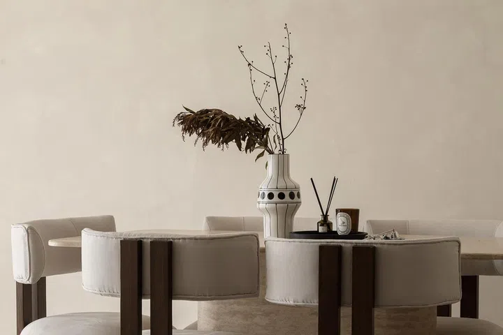 A statement travertine dining table fits into this 5-room resale HDB in Edgedale Plains' Wabi-Sabi interior design theme.