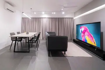 Large big screen Sony Bravia TV in a living room with dining table set. Photo by Builders Plus.