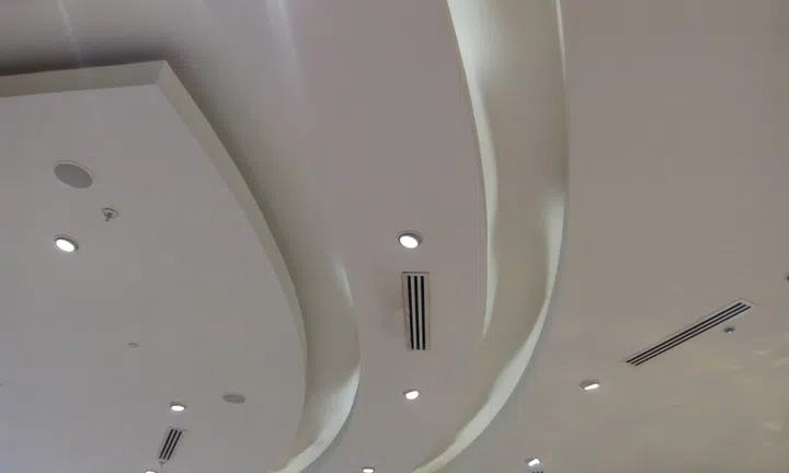 Gypsum false ceiling and Coves for indirect lighting to make a decorative look for an mumbai international airport and spot lights.