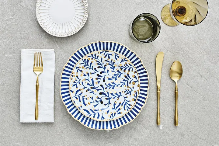 Royal beaded white salad plate, $15.90; Bitossi Italy Abracadabra tempeste plate, $61.90; Bitossi Italy Abracadabra salad plate, $61.90; Matt gold cutlery, $10.90 each; Bitossi set of 6 textured wine goblets/glasses, $189.90, all from Lovera Collections.