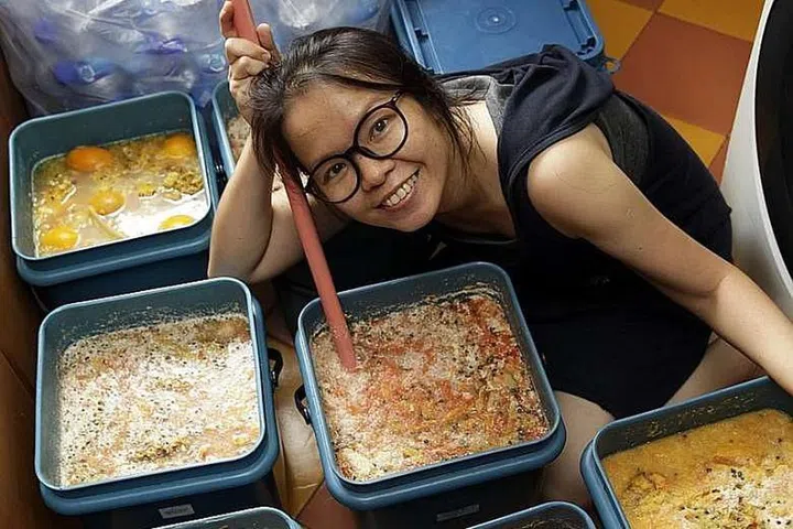 Volunteer Ng Wai Sen with her homemade garbage enzymes she uses for cleaning purposes.PHOTO: GIN TAY FOR THE STRAITS TIMES