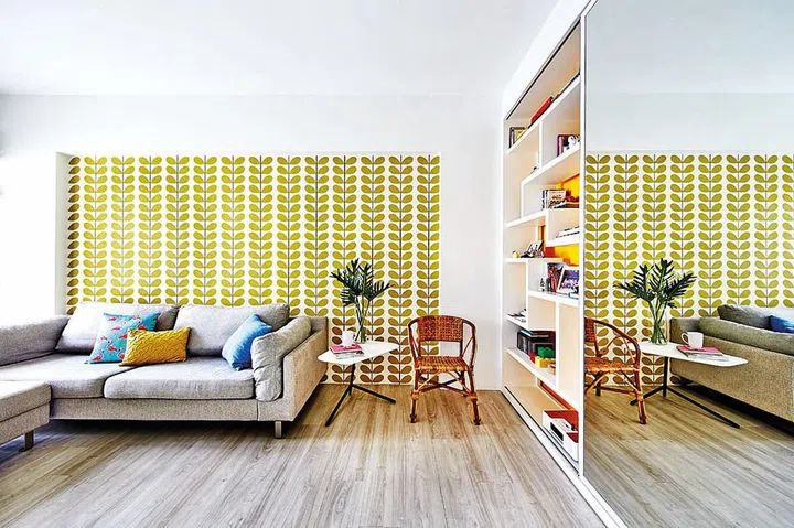 Carole likes to jazz up her Boconcept fabric sofa with colourful, printed cushions. The rattan chair is a memento from her childhood home.