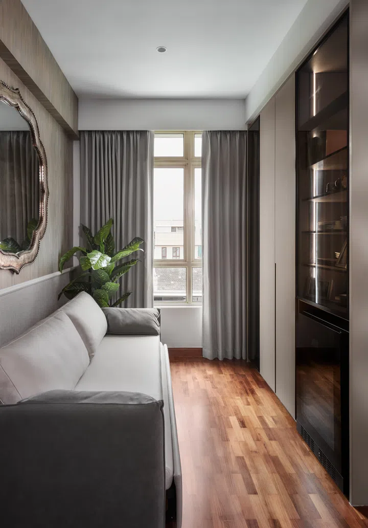 The reimagined guest bedroom now doubles as a sitting room, with shelving and a wine chiller close at hand for relaxed downtime.