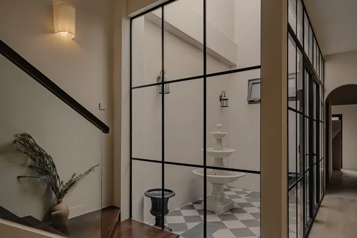 Rather than incur the high cost of covering the airwell, the couple transformed it into a compact courtyard.
