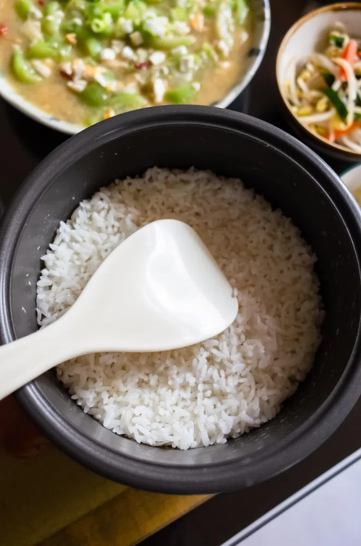 chinese dinner with rice bucket and dishes on table