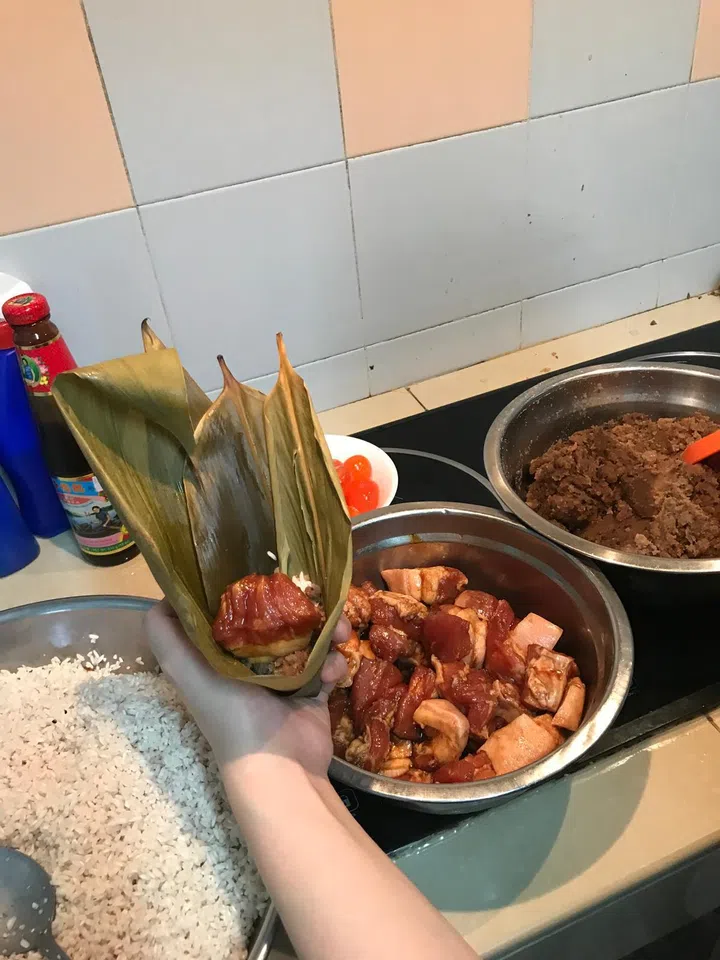 Candy in her in-laws’ home kitchen in Kuala Lumpur, attempting to make Chinese dumplings with his family in 2020.