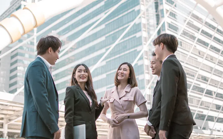 Group of business people wearing formal suit, working, talking and discussing their jobs together outdoor.