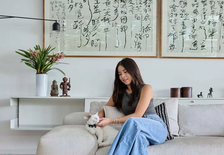 Daughter and cat poses for a picture on the sofa in the living room in their 3,990 sq ft semi-detached home at Frankel Estate.