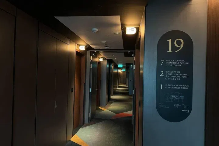 A list of Quincy House’s property amenities placed at the lift lobby.