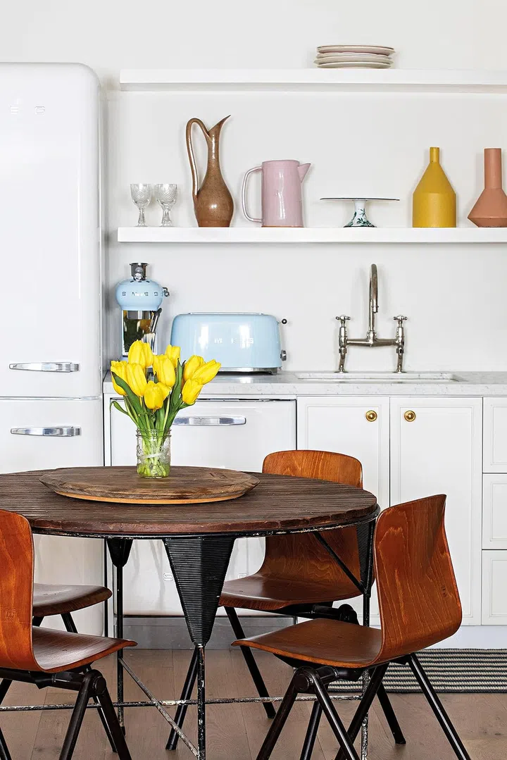 The wooden tabletop is complemented by the sleek design of the dining chairs in a similar material.