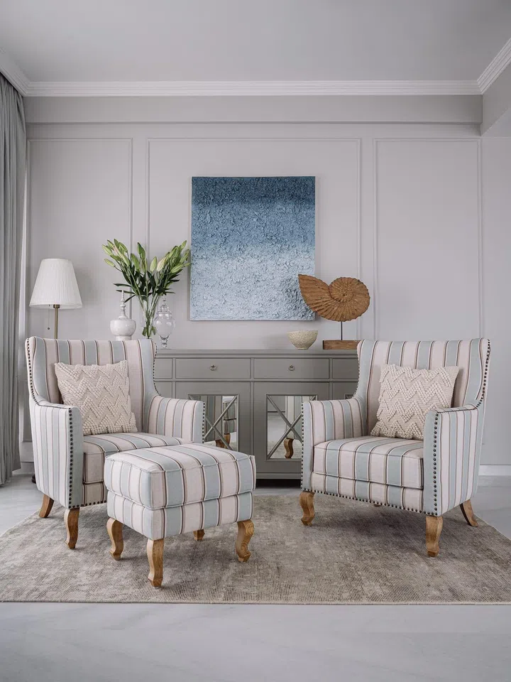 Black and white pinstripe chairs in a 60-year-old couple’s 2-bedroom apartment in Parsi, Mumbai.
