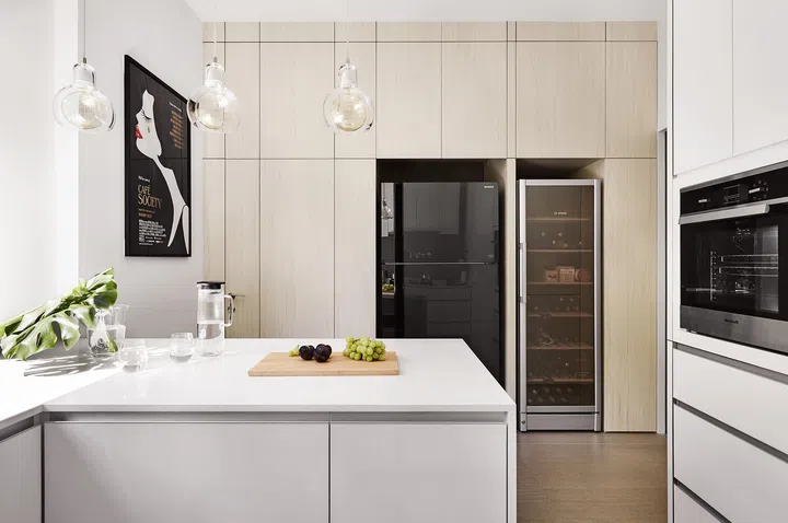 Kitchen island, fridge, and a wine fridge in a 3-bedroom condo in East Coast.