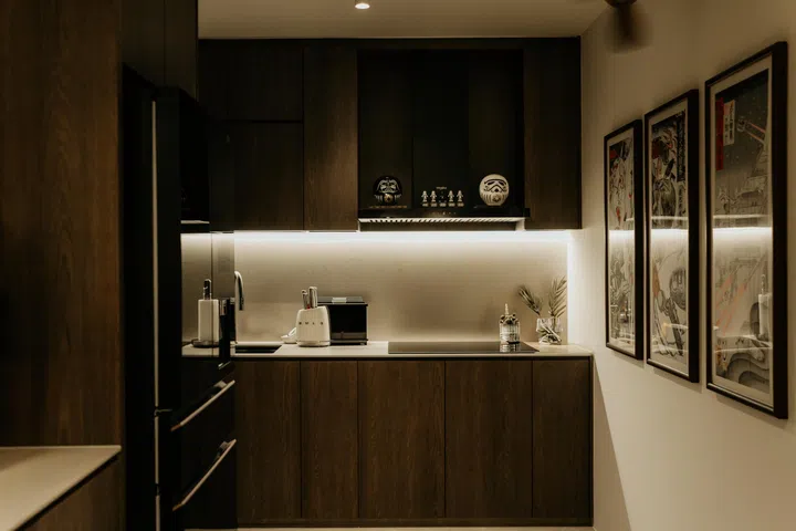 Dark wood cabinetry and soft lighting create a calm backdrop, allowing the Star Wars elements to sit comfortably within the overall palette.