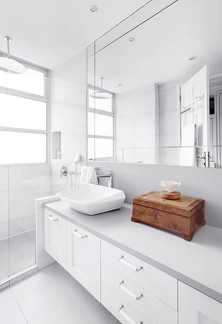 The master bathroom exudes a contemporary spa feel with its white and pale grey palette.